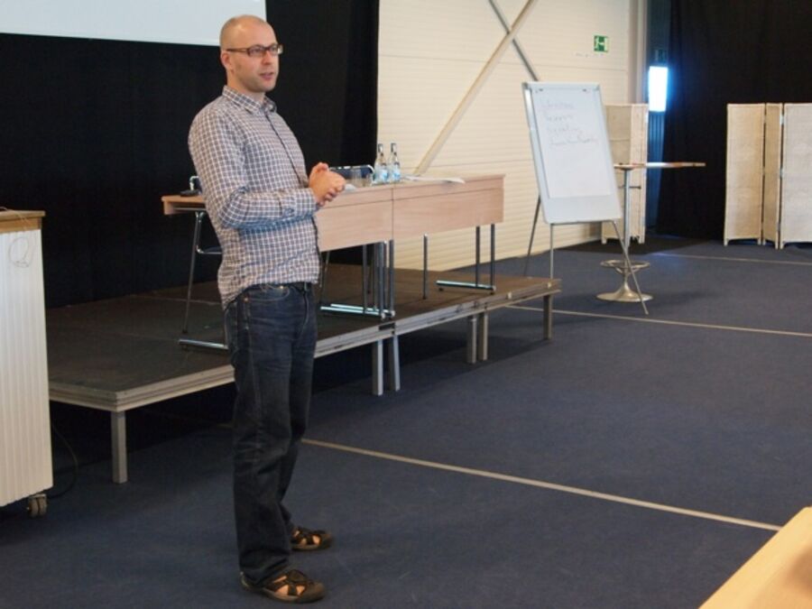 A speaker clasping his hands