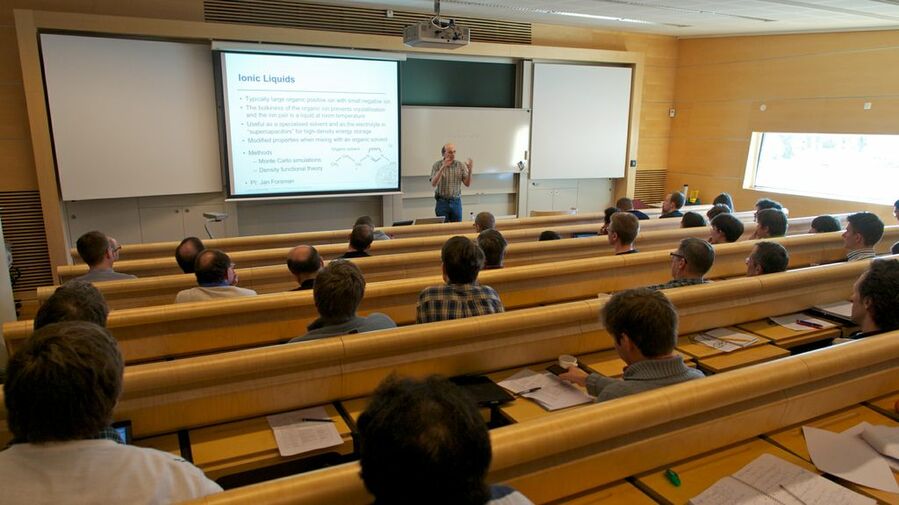 Magnus Ullner talking about ionic liquids seen from the back of the auditorium.