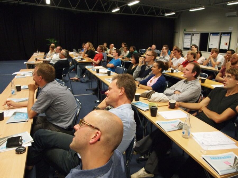 Rows of participants listening to a talk.